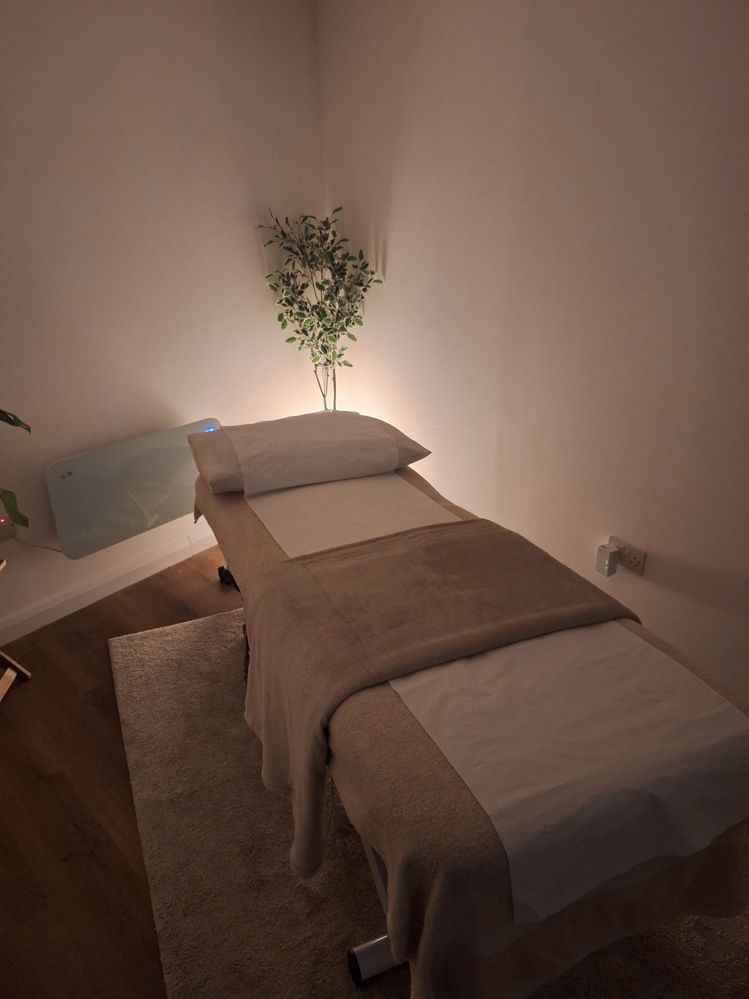The softly lit treatment room with a healing table